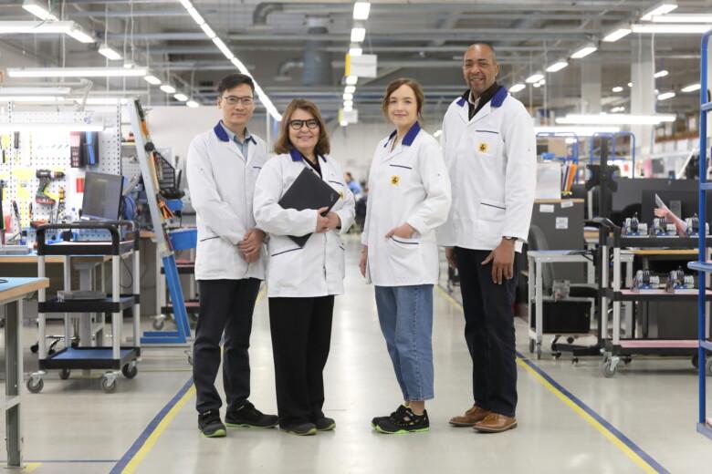 Four Scanfil employees at modern and highly equipped Scanfil factory. Scanfil’s committed and highly skilled employees ensure top‑tier quality at every stage of manufacturing.