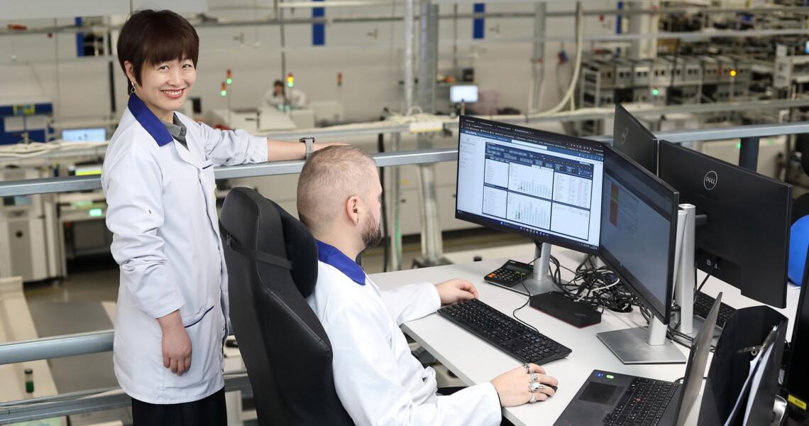 Scanfil factory employees monitoring data in Scanfil factory.